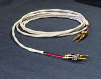 white speaker cable with welded banana plugs